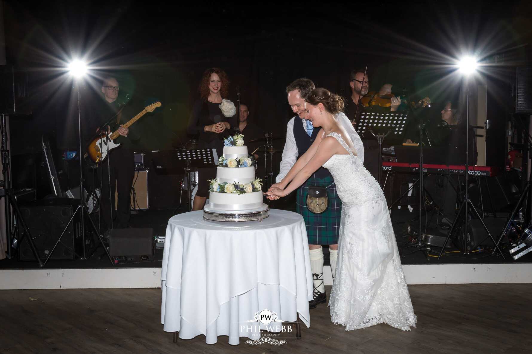 Manor by the Lake Wedding Photography bride and groom cutting the cake
