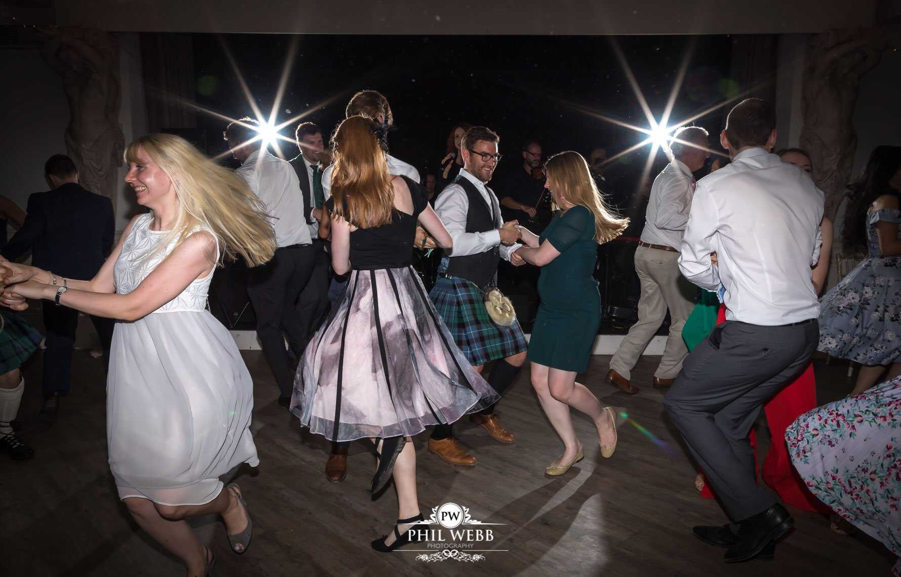 Manor by the Lake Wedding Photography bride and grooms guests dancing