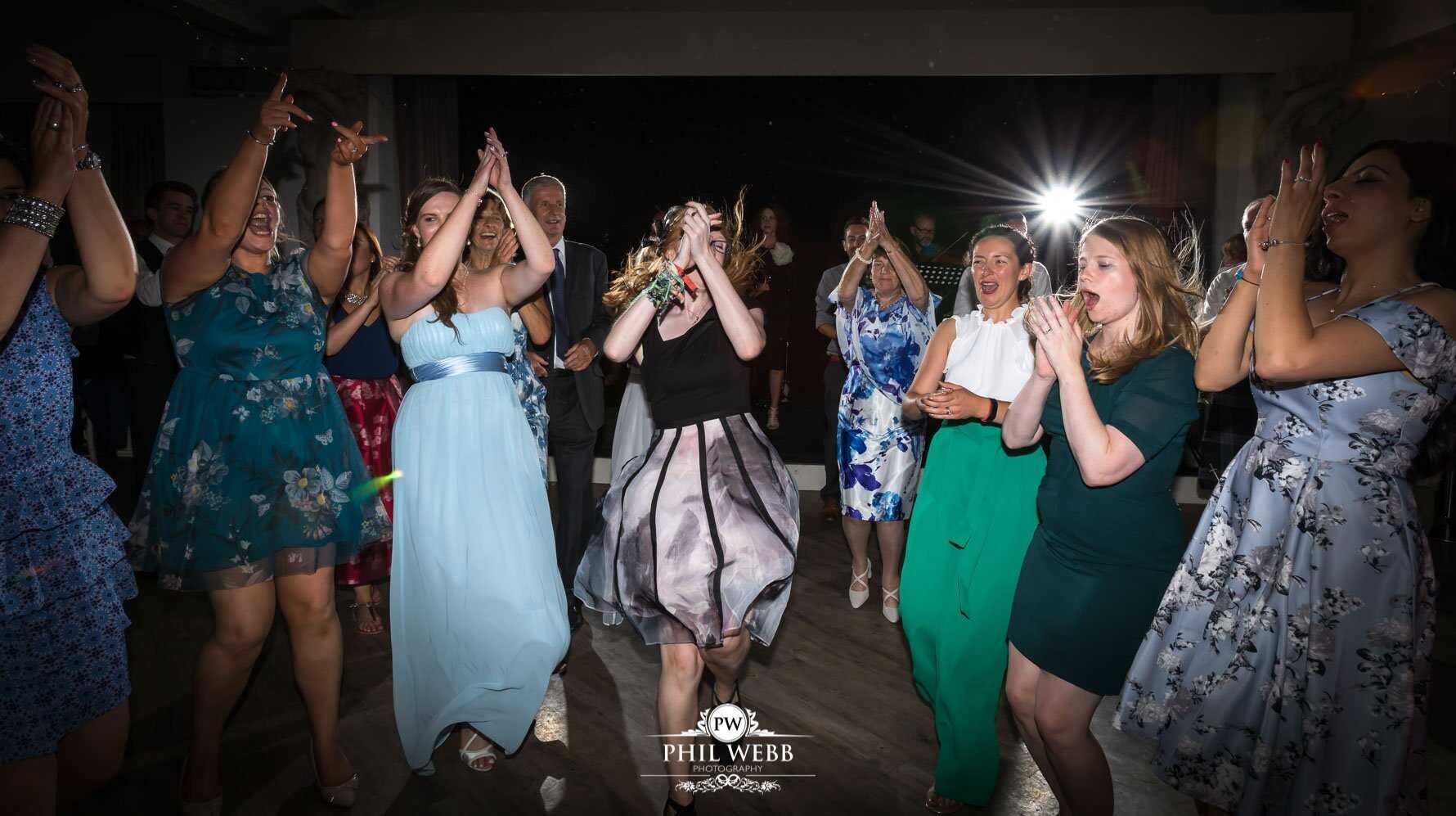 Manor by the Lake Wedding Photography bride and grooms guests dancing