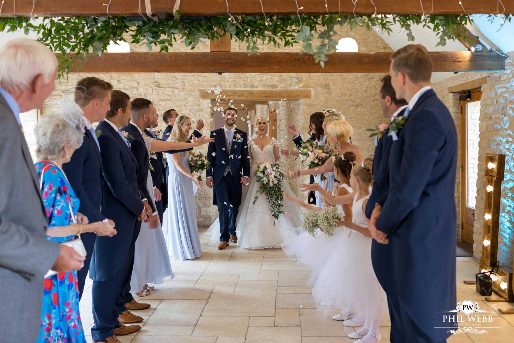 Kingscote Barn Wedding Photography bride and groom confetti