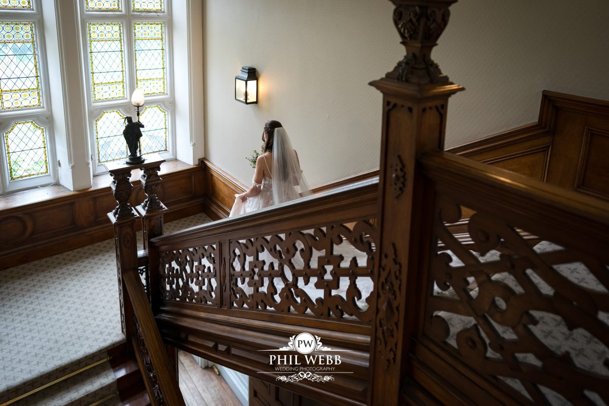 Clevedon Hall Wedding Photography bride walking down the stairs
