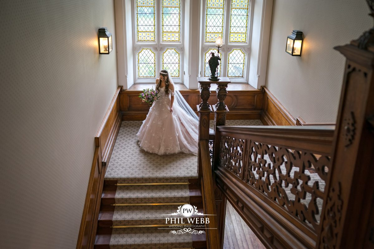 Clevedon Hall Wedding Photography bride walking down the stairs