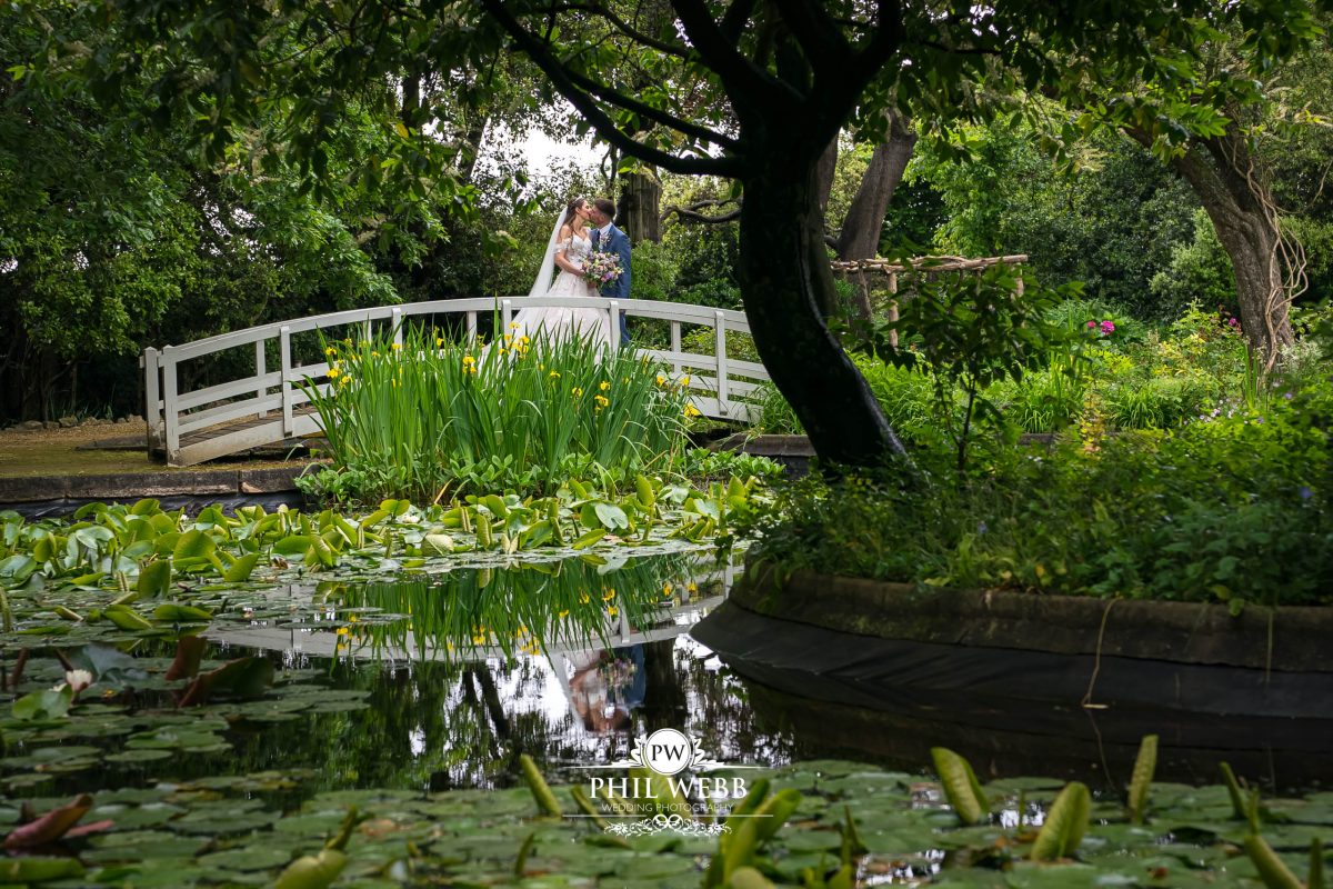 Clevedon Hall Wedding Photography bride and groom portrait by the lake
