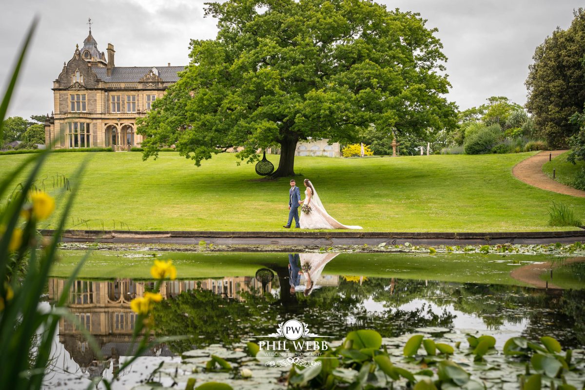 Clevedon Hall Wedding Photography bride and groom portrait by the lake