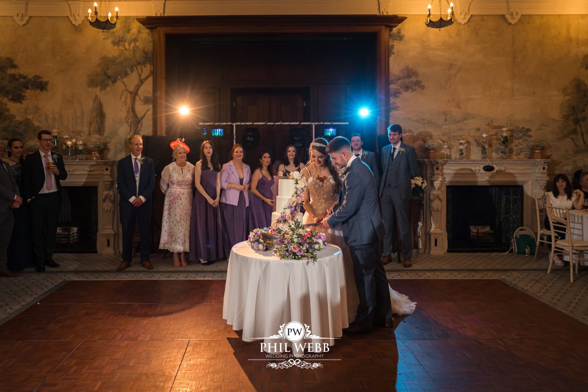 Clevedon Hall Wedding Photography bride and groom cutting the cake