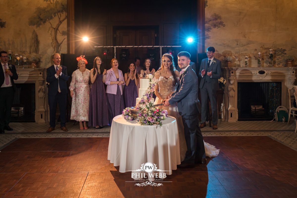 Clevedon Hall Wedding Photography bride and groom cutting the cake