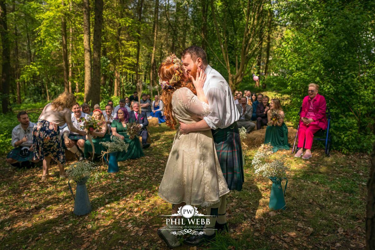 Enchanted Woodland Wedding Hereford bride and groom first kiss