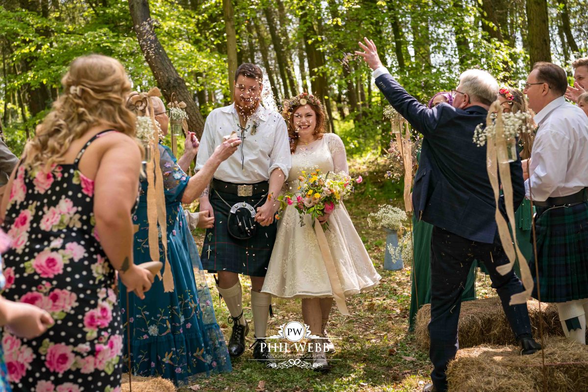 Enchanted Woodland Wedding Hereford bride and groom walking confetti