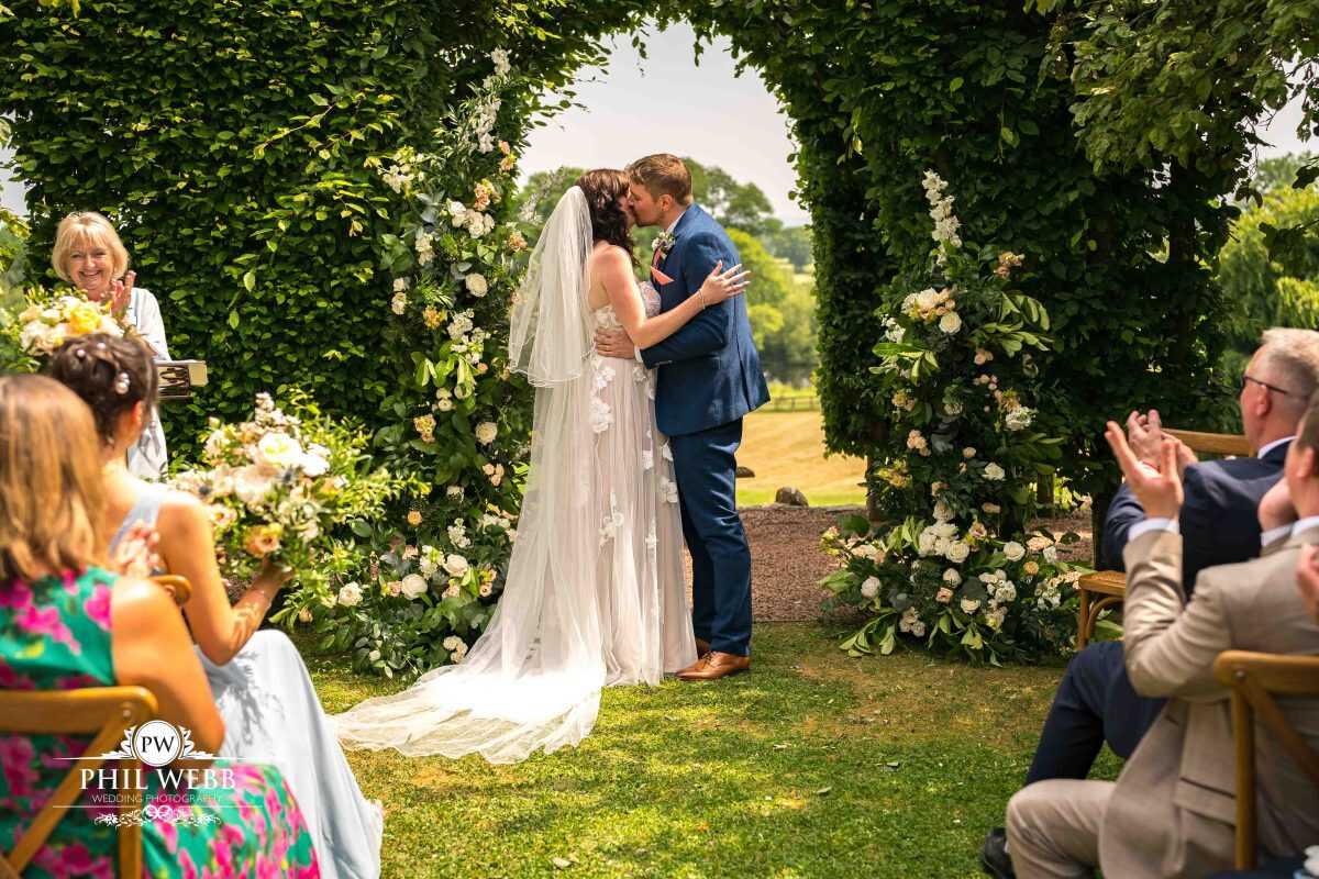 Pauntley Court Wedding Venue bride and groom wedding ceremony first kiss
