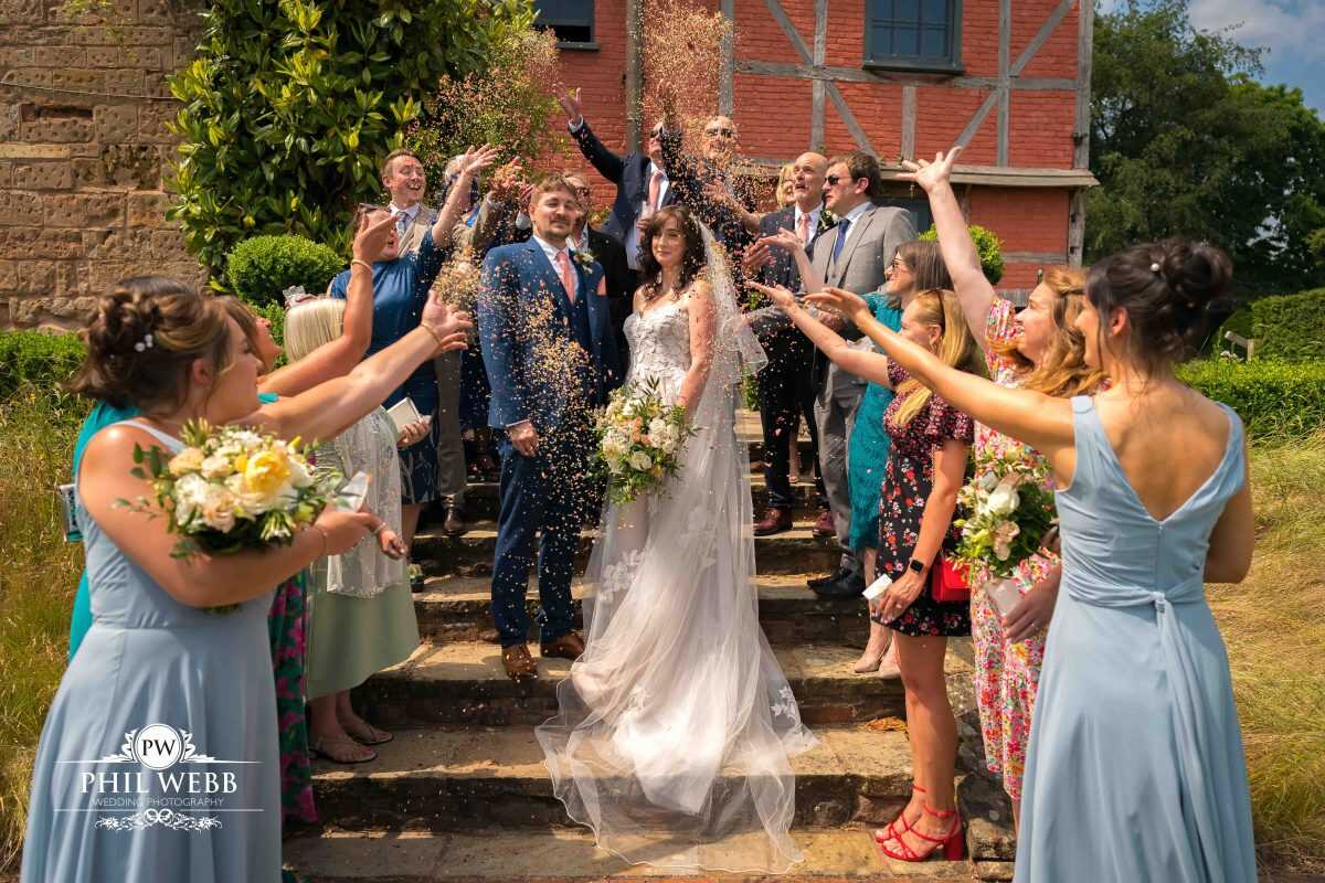 Pauntley Court Wedding Venue bride and groom confetti