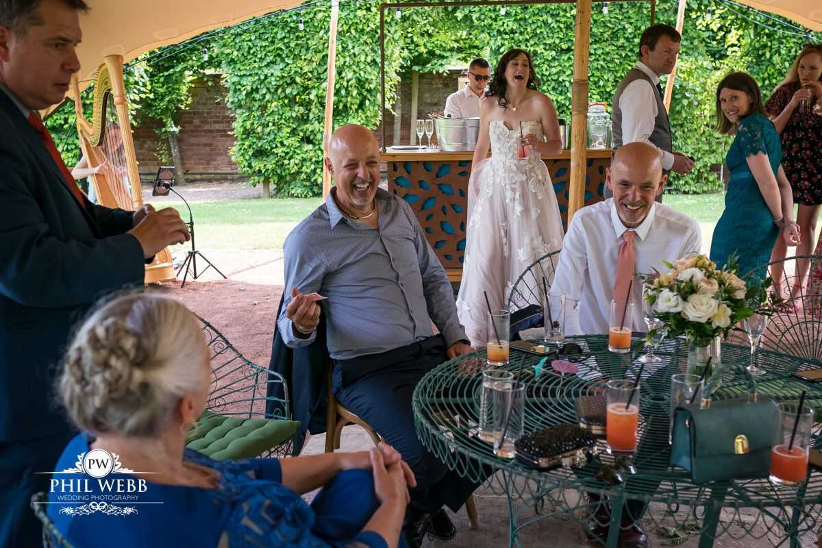 Pauntley Court Wedding Venue bride and groom with magician