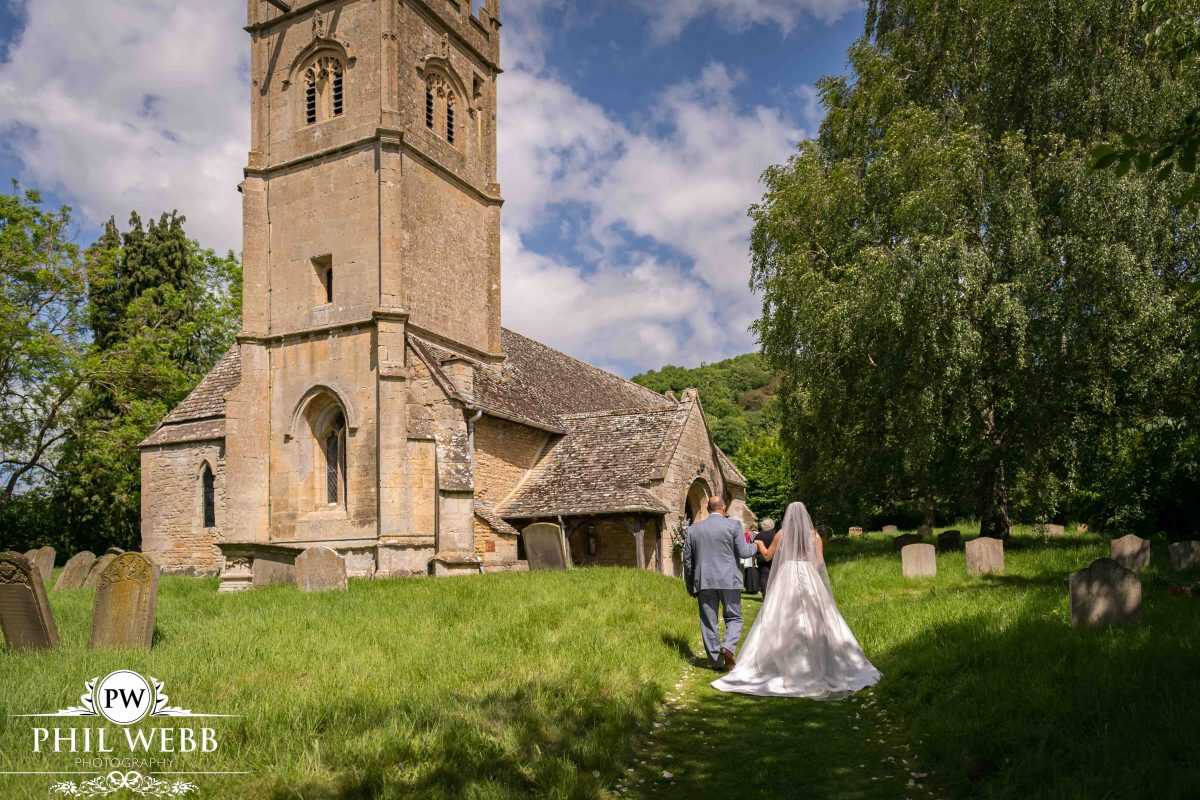bride walking to church with her father