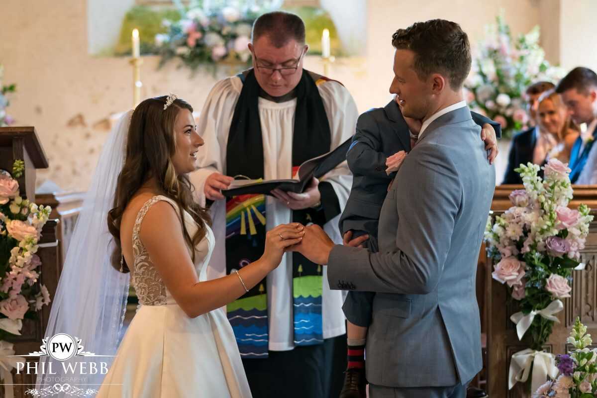 bride and groom wedding ring exchange in church