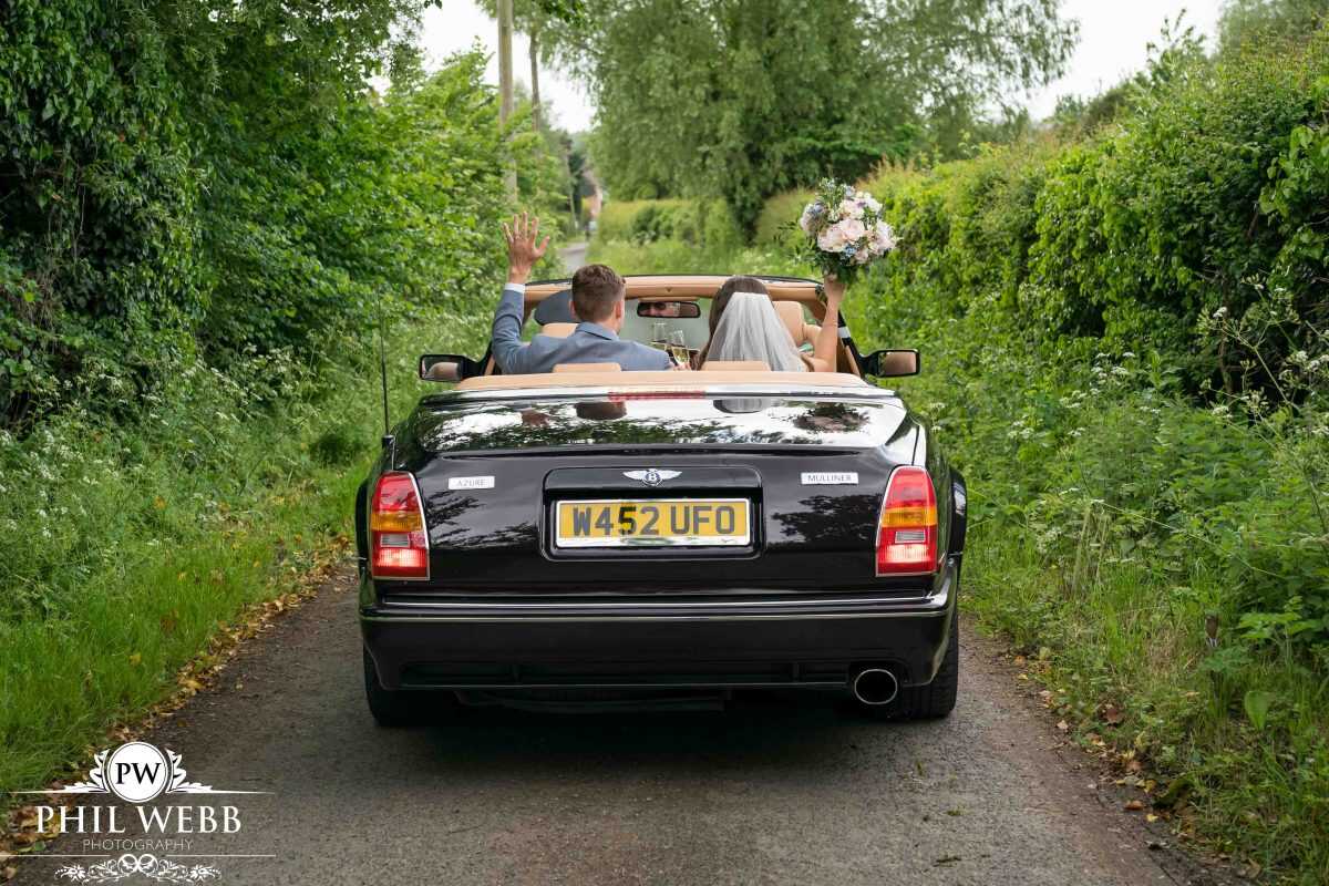 Bride and Groom in Bentley car