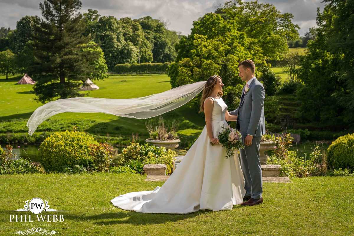 Bride and Groom Portrait at Cowley Manor by the lake