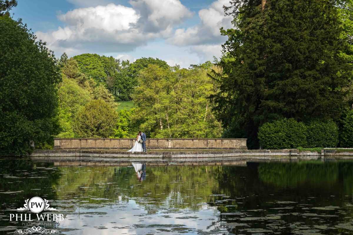 Bride and Groom Portrait at Cowley Manor by the lake