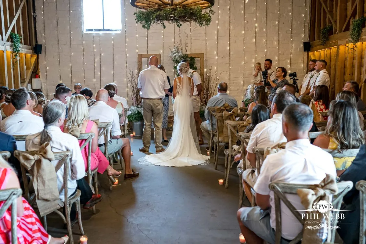 Over barn at Over Farm Wedding Photography bride and groom indoor ceremony