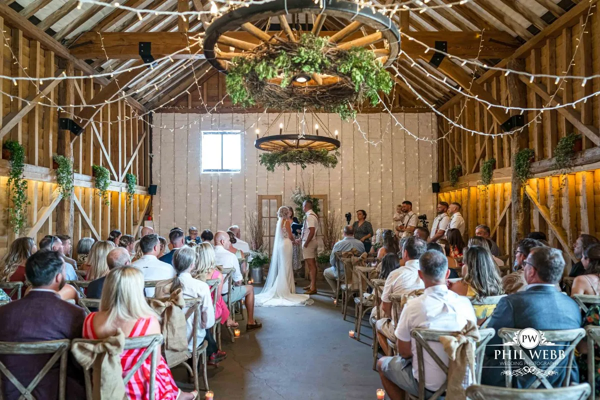 Over barn at Over Farm Wedding Photography bride and groom indoor ceremony