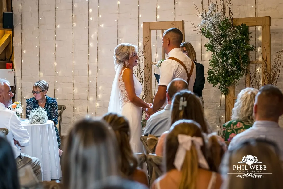 Over barn at Over Farm Wedding Photography bride and groom indoor ceremony