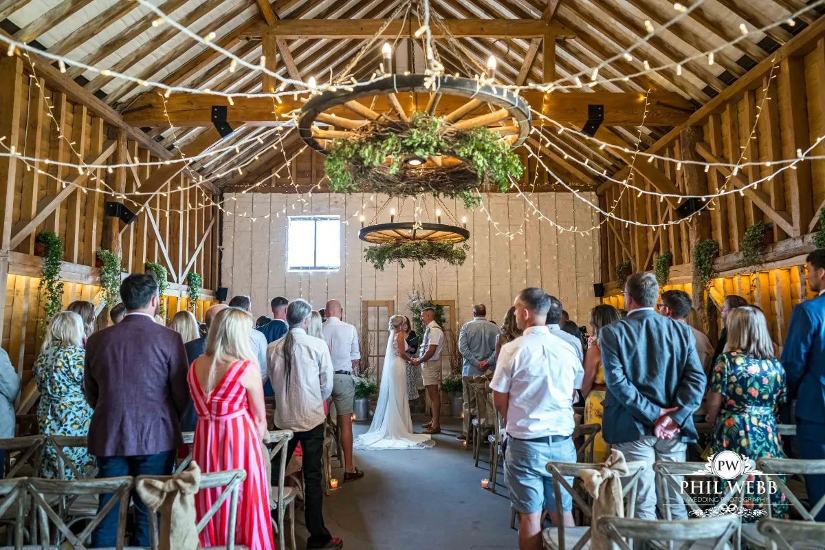 Over barn at Over Farm Wedding Photography bride and groom indoor ceremony
