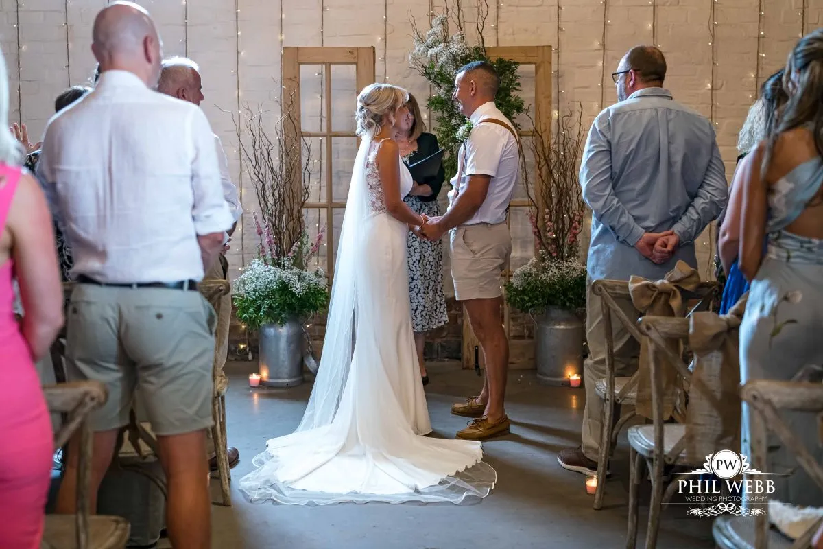 Over barn at Over Farm Wedding Photography bride and groom indoor ceremony