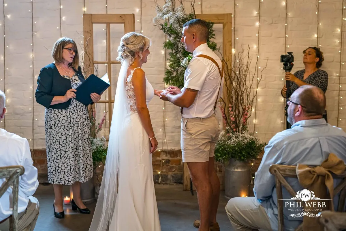 Over barn at Over Farm Wedding Photography bride and groom indoor ceremony