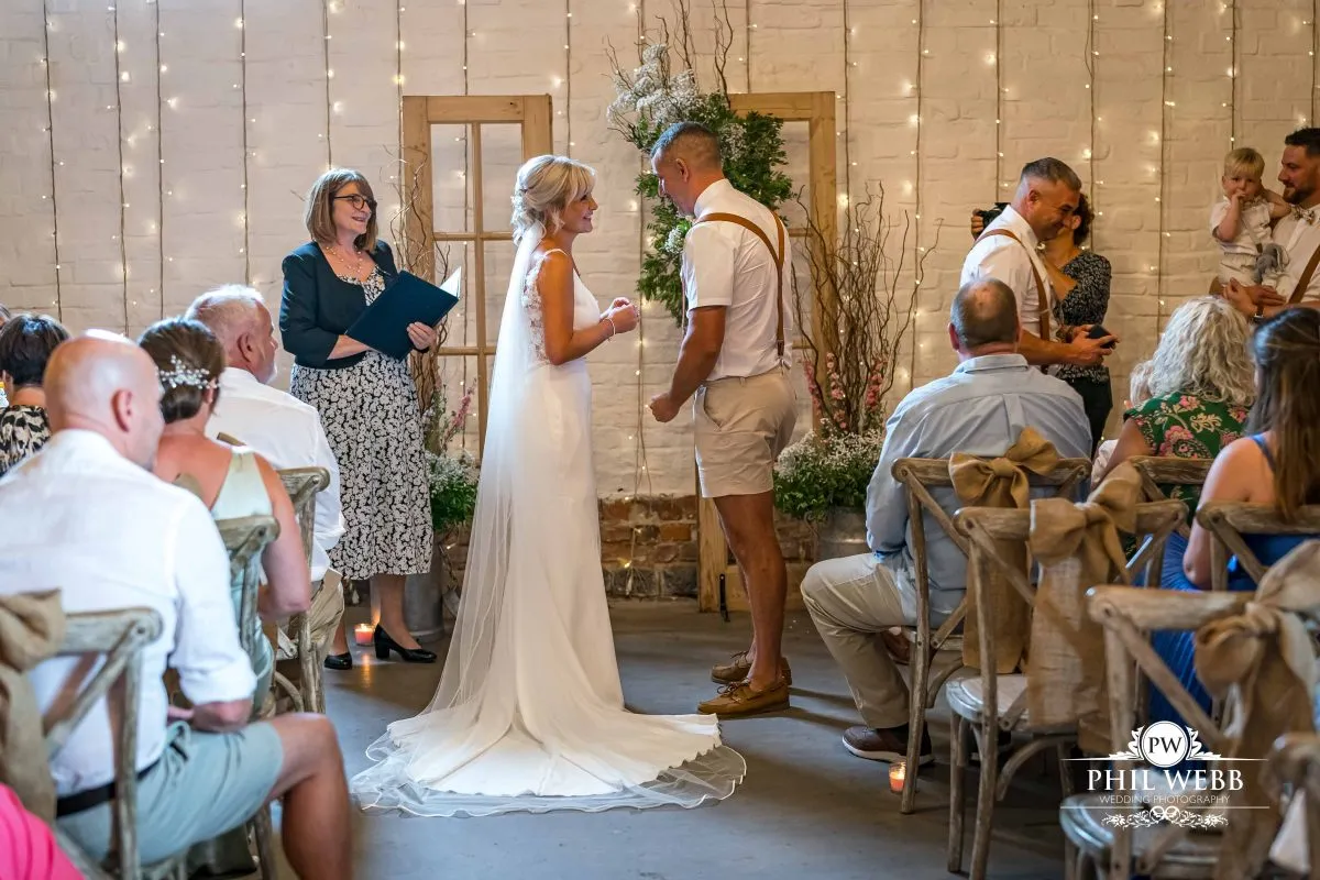 Over barn at Over Farm Wedding Photography bride and groom indoor ceremony
