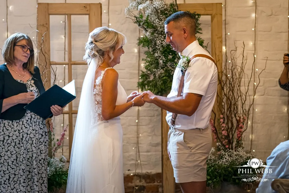 Over barn at Over Farm Wedding Photography bride and groom indoor ceremony
