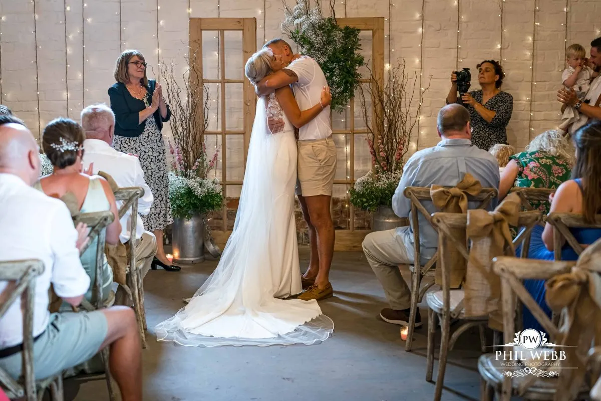Over barn at Over Farm Wedding Photography bride and groom indoor ceremony
