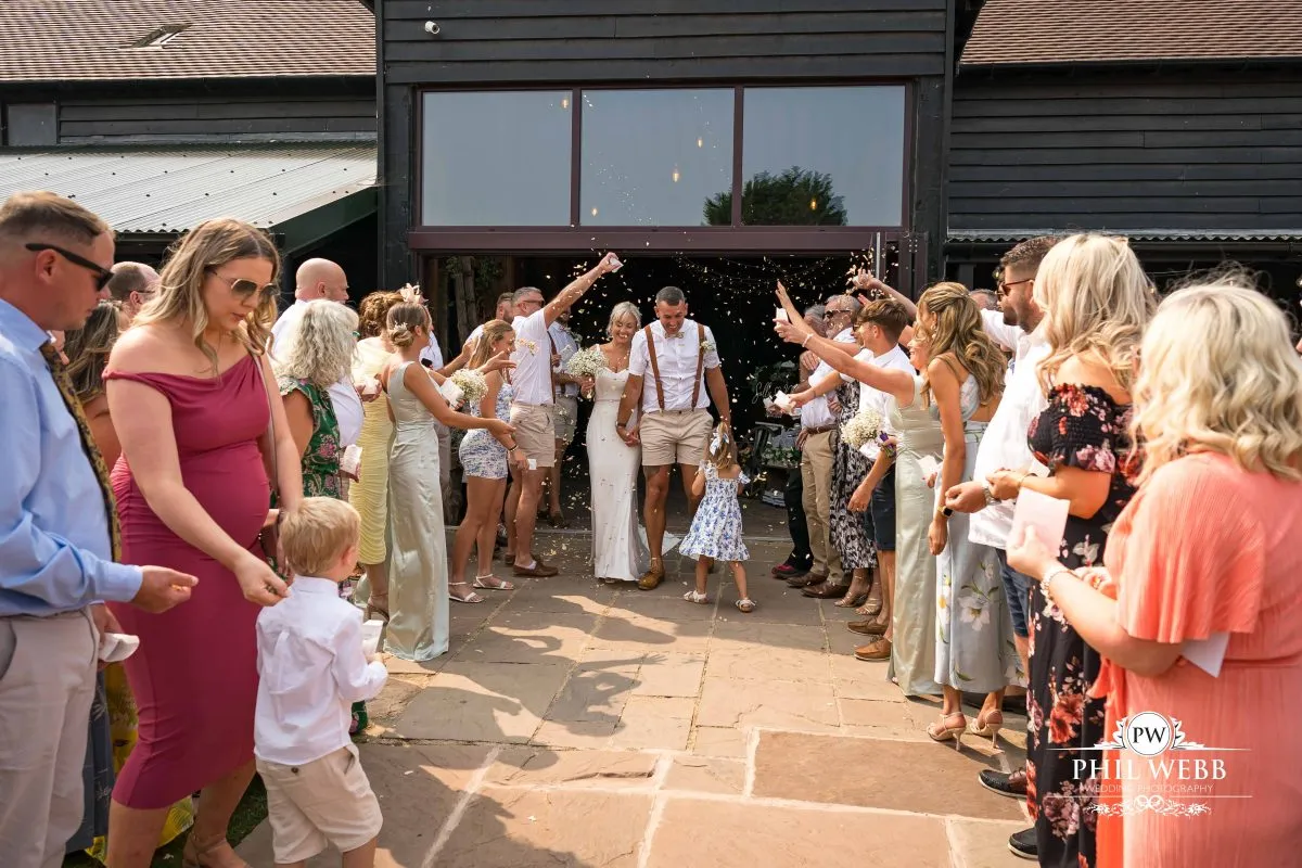 Over barn at Over Farm Wedding Photography bride and groom confetti