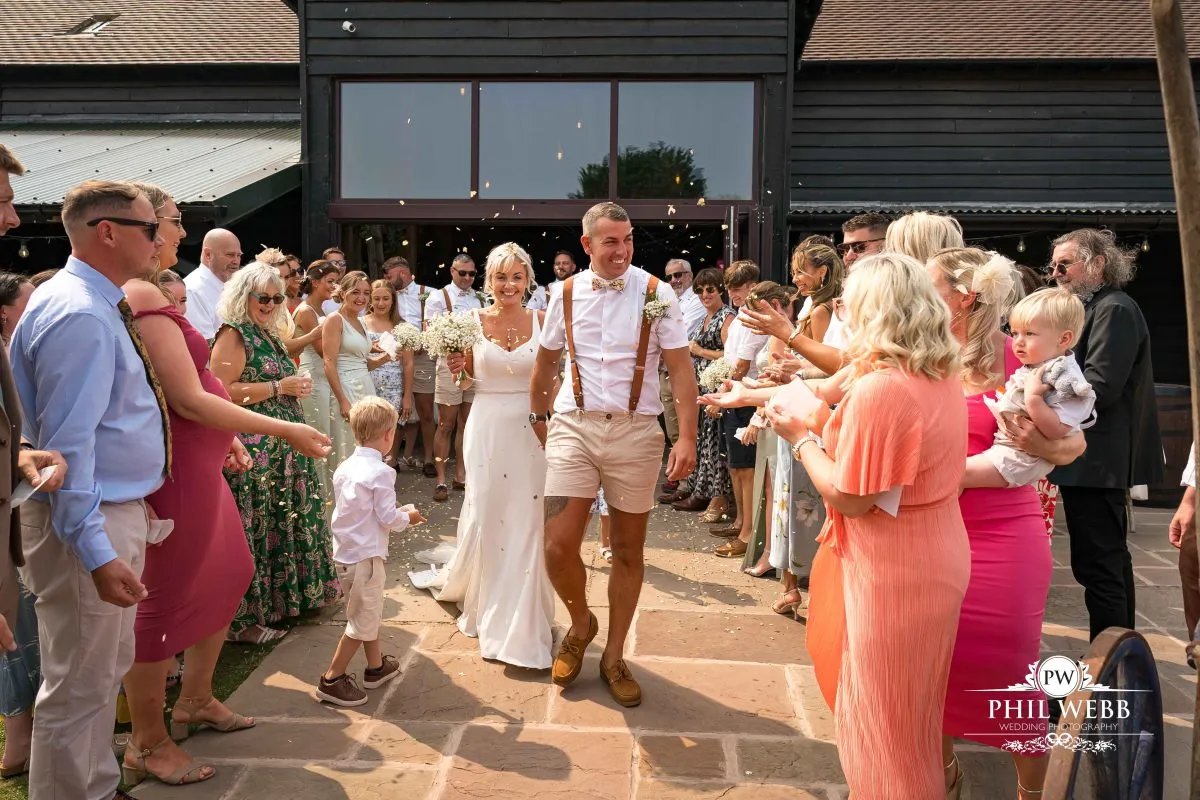 Over barn at Over Farm Wedding Photography bride and groom confetti
