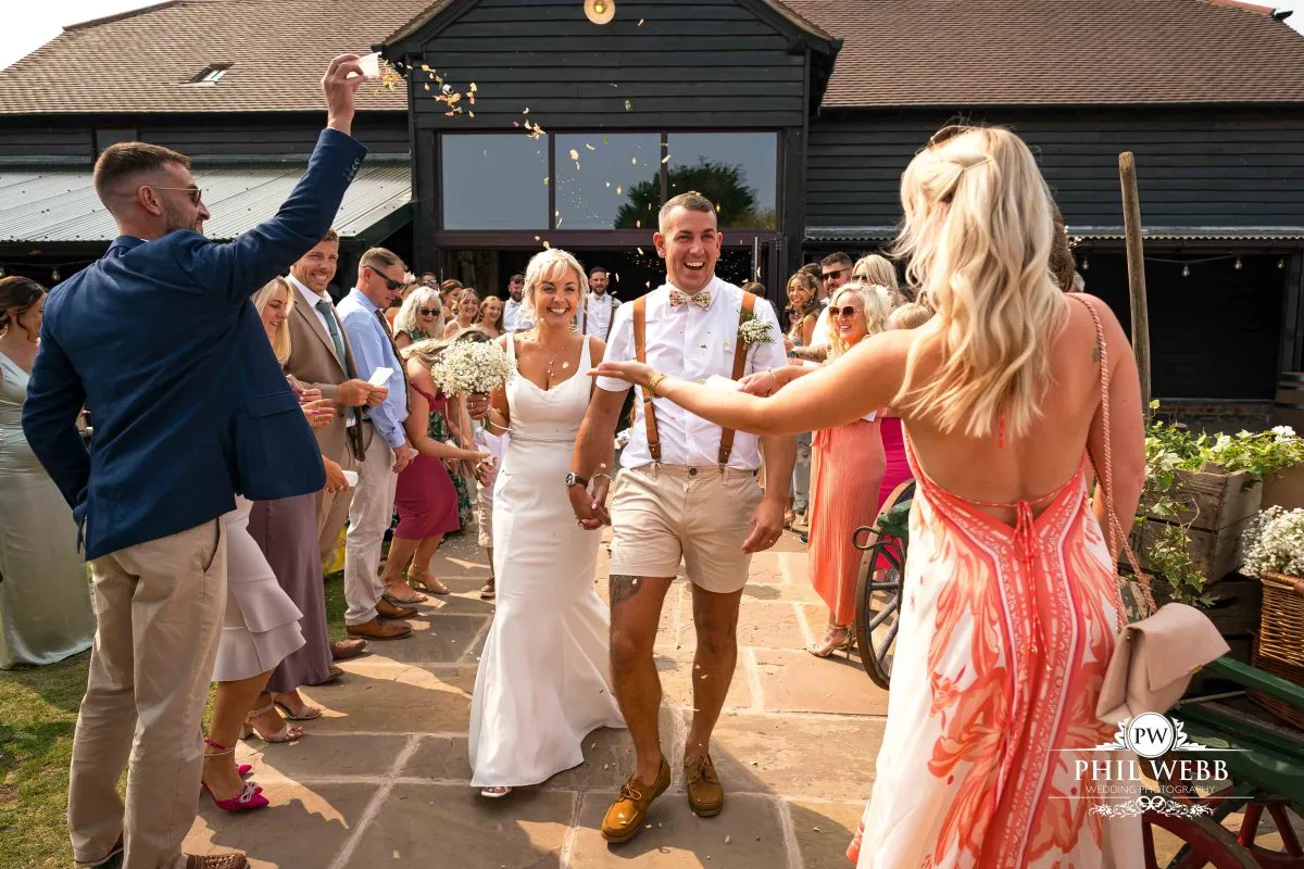 Over barn at Over Farm Wedding Photography bride and groom confetti