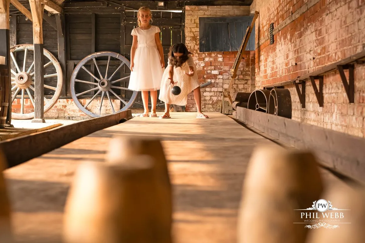 Over barn at Over Farm Wedding Photography guests playing skittles