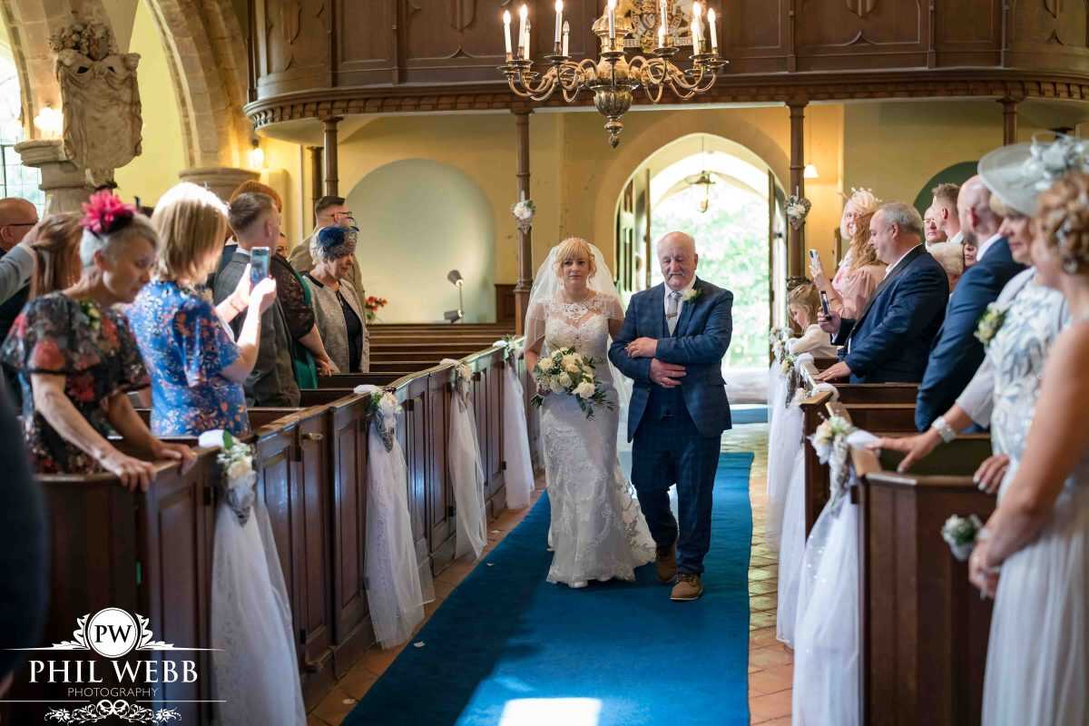 bride walking down the aisle with dad