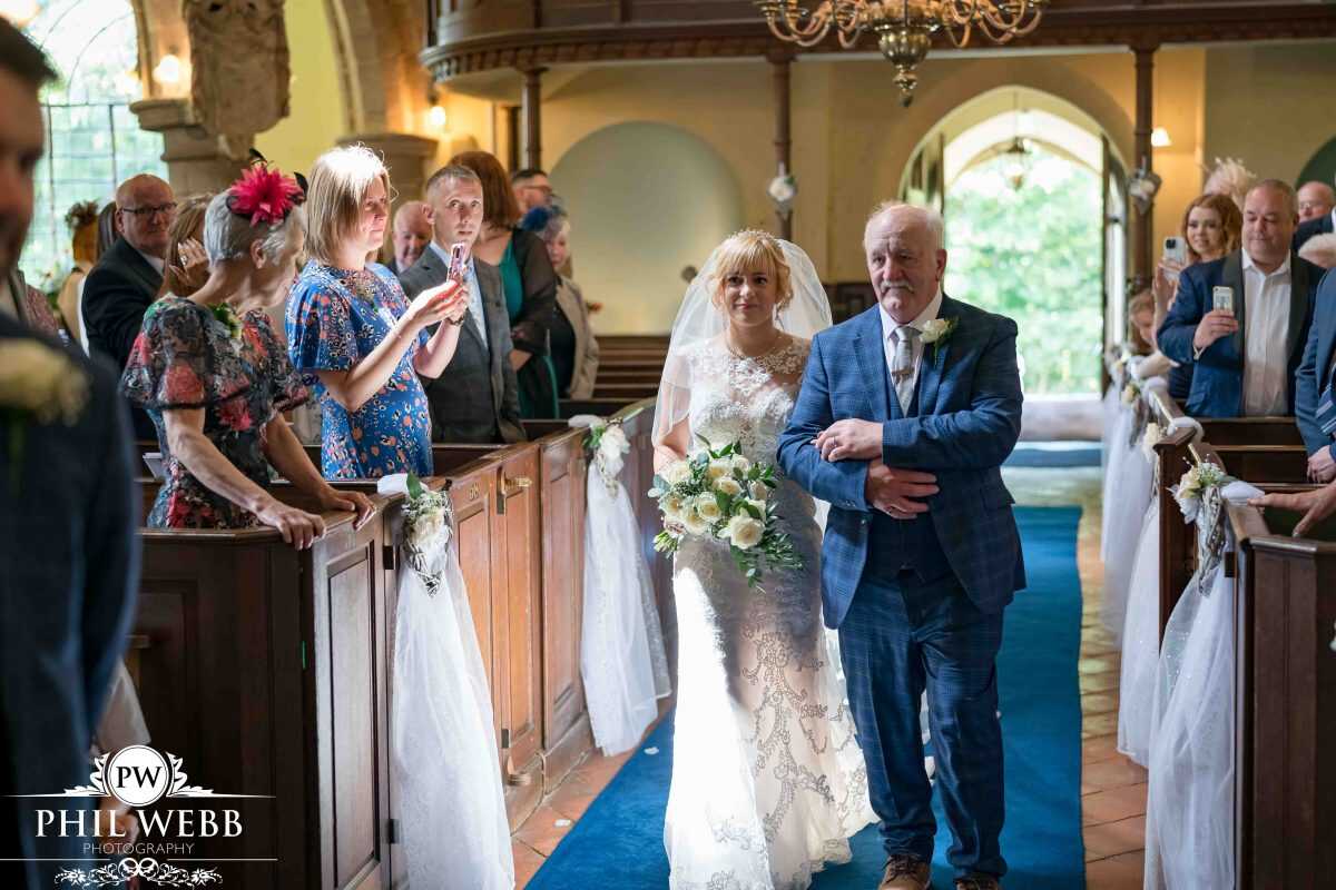 bride walking down the aisle with dad