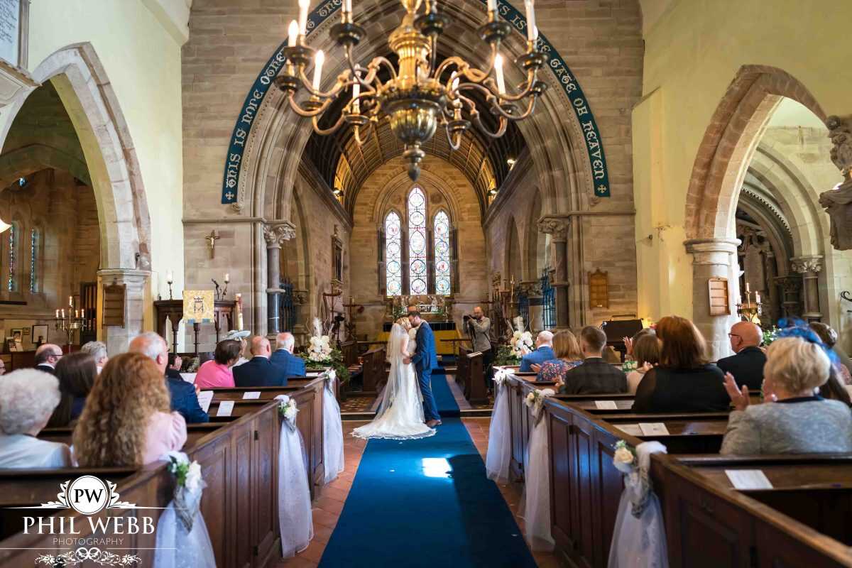 bride and groom wedding ceremony first kiss in church