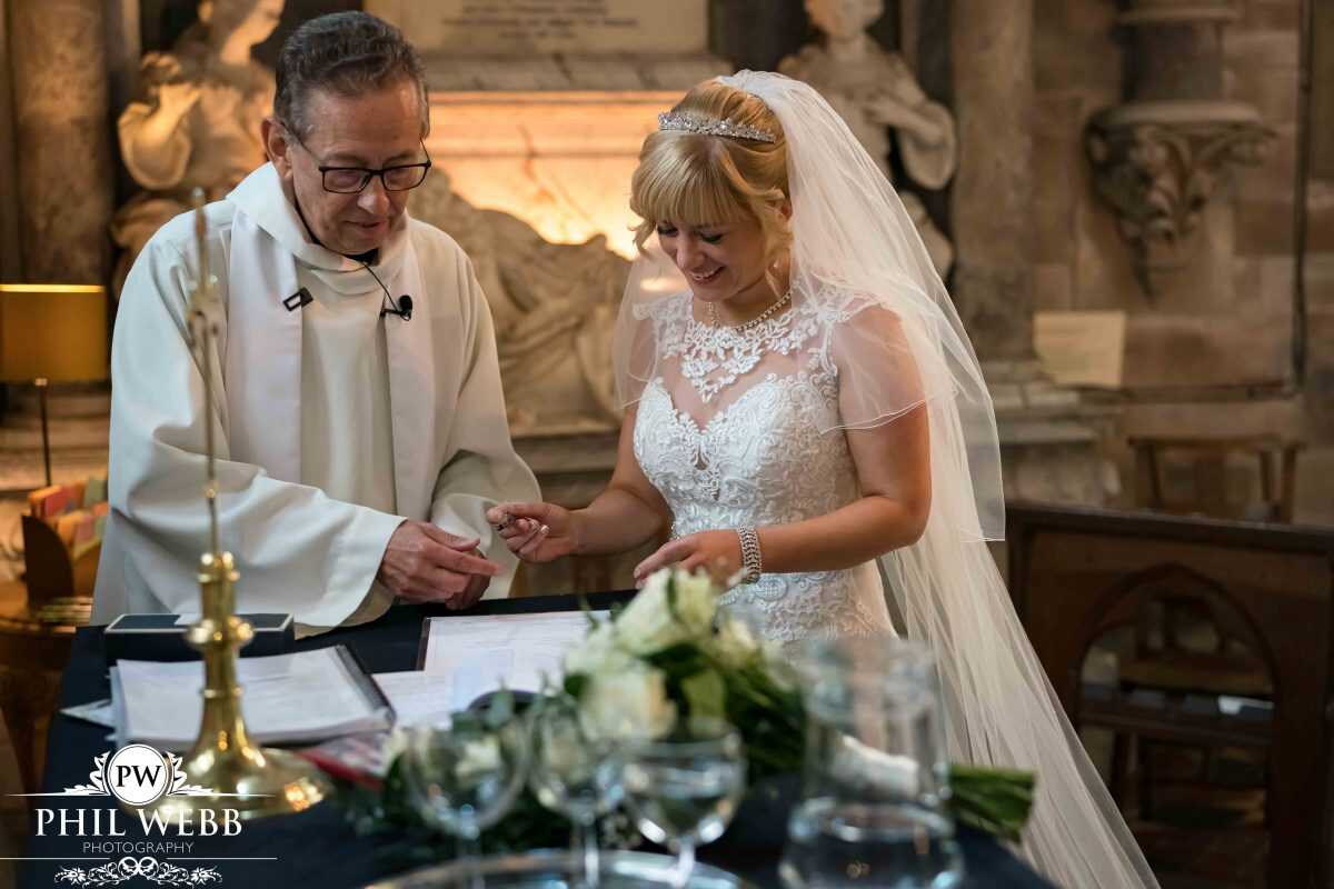 bride signing register wedding ceremony in church