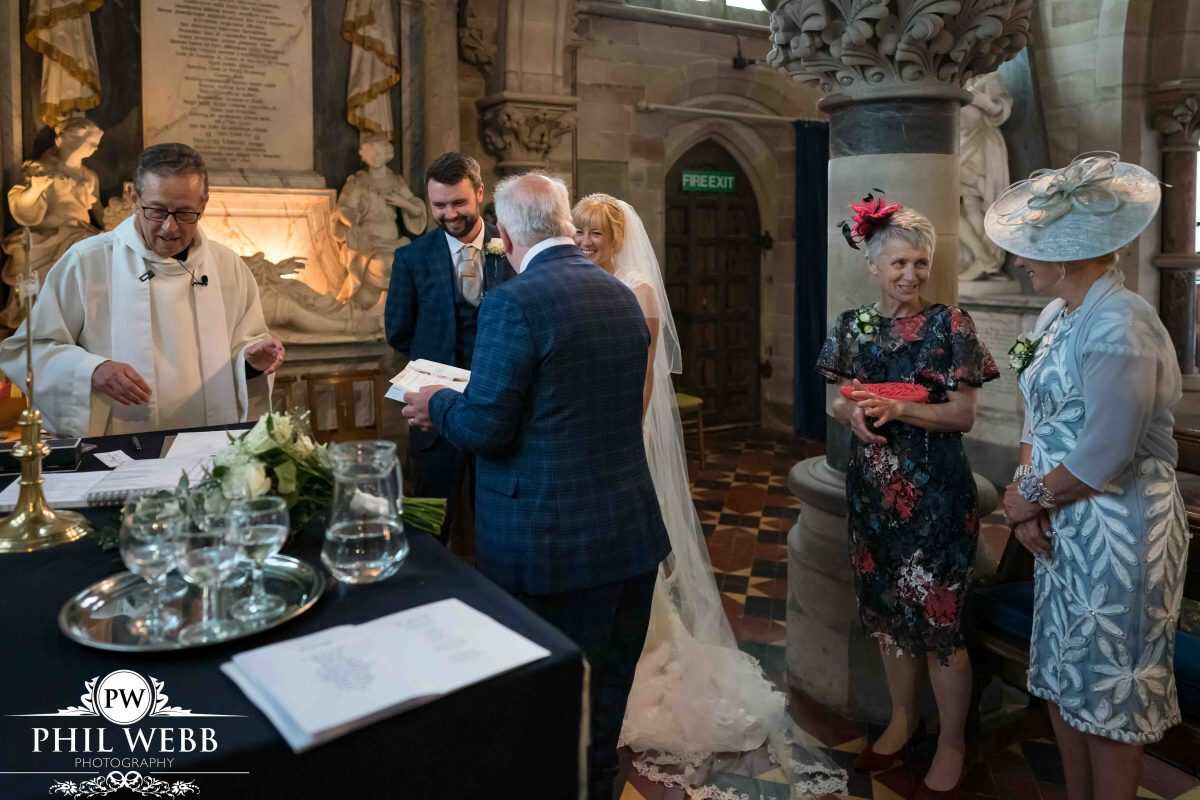 bride and groom wedding ceremony in church signing register