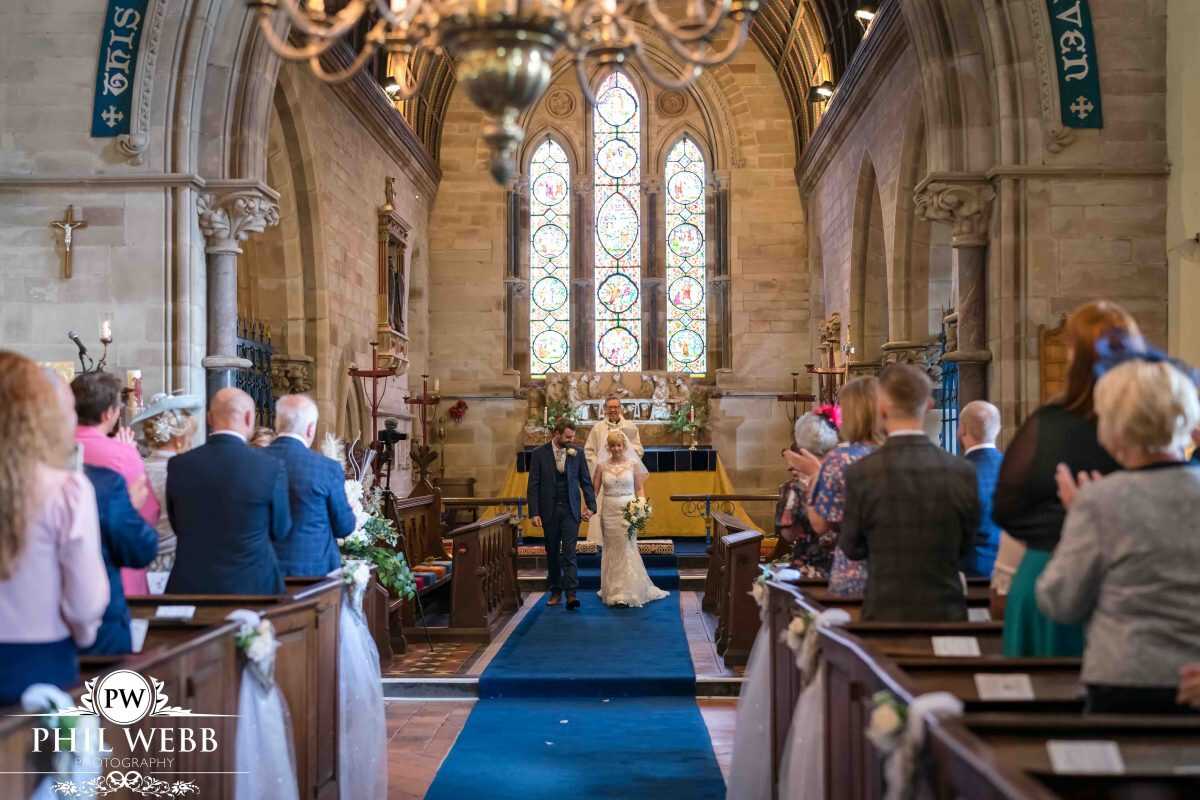 bride and groom wedding ceremony in church walking down the aisle
