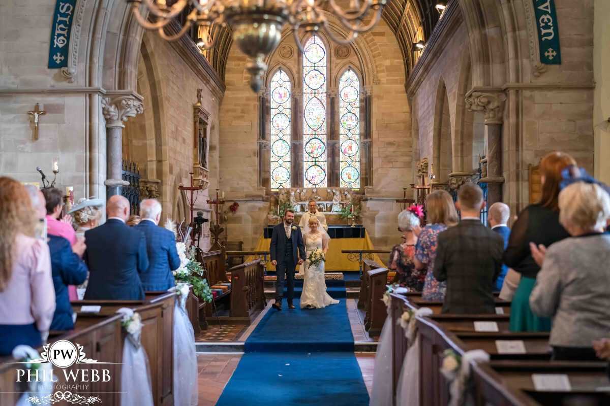 bride and groom wedding ceremony in church walking down the aisle