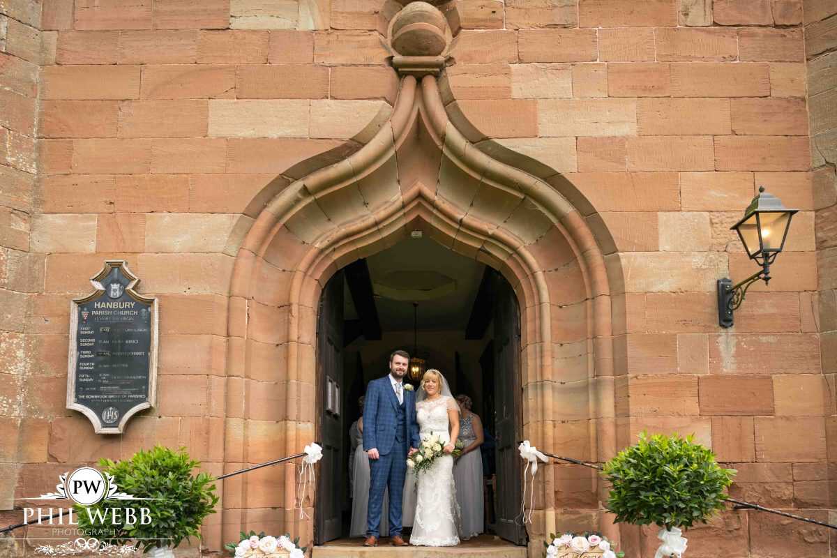 bride and groom standing outside church