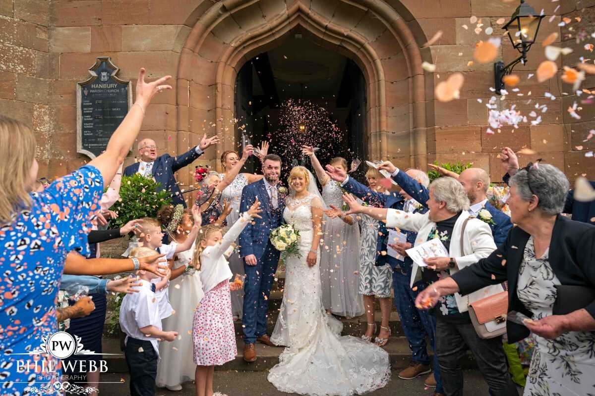 bride and groom confetti shot outside church
