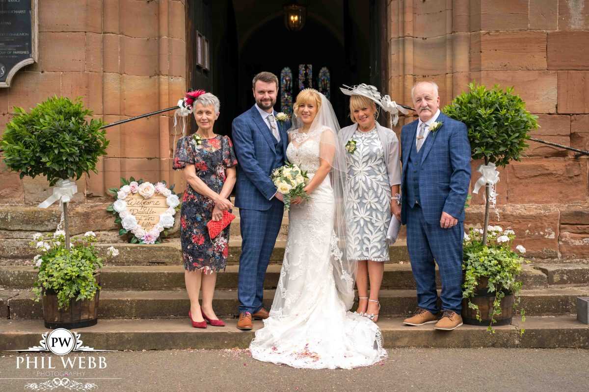 bride and groom group picture standing outside church