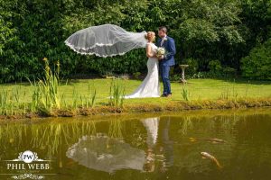 bride and groom portrait redhouse barns veil flying