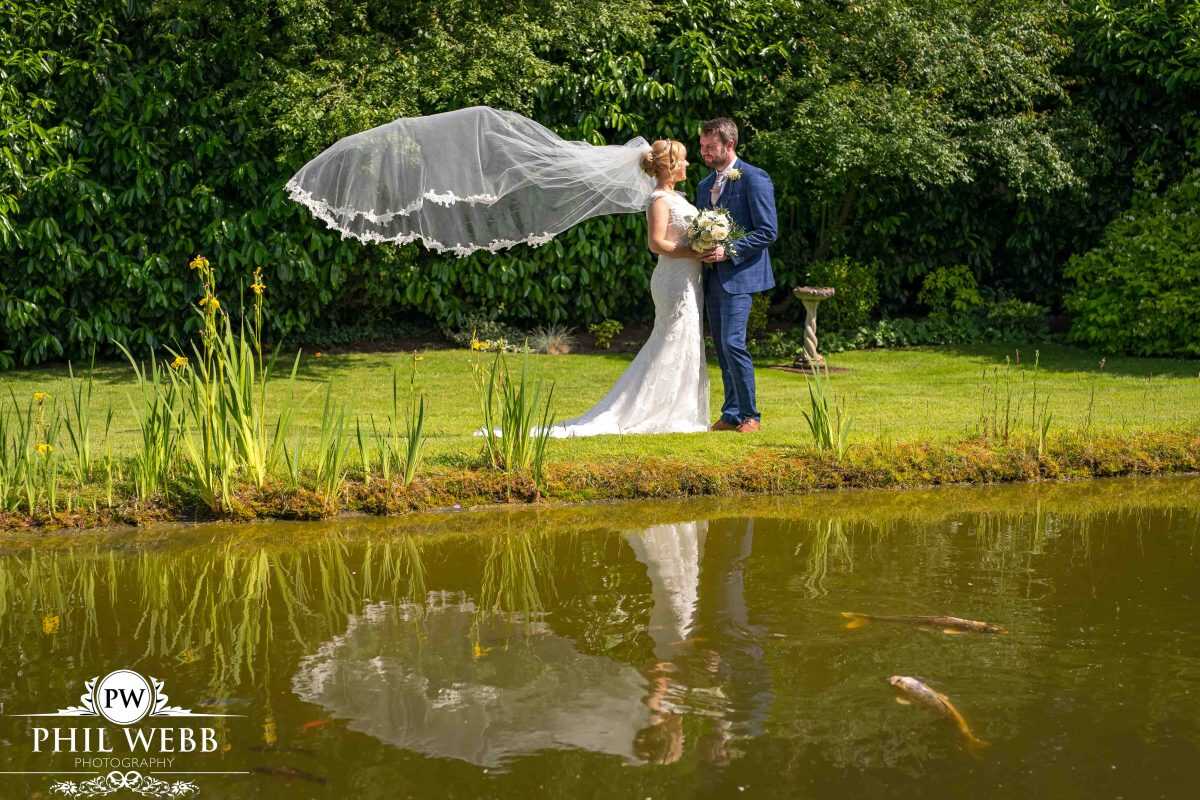 bride and groom portrait redhouse barns veil flying
