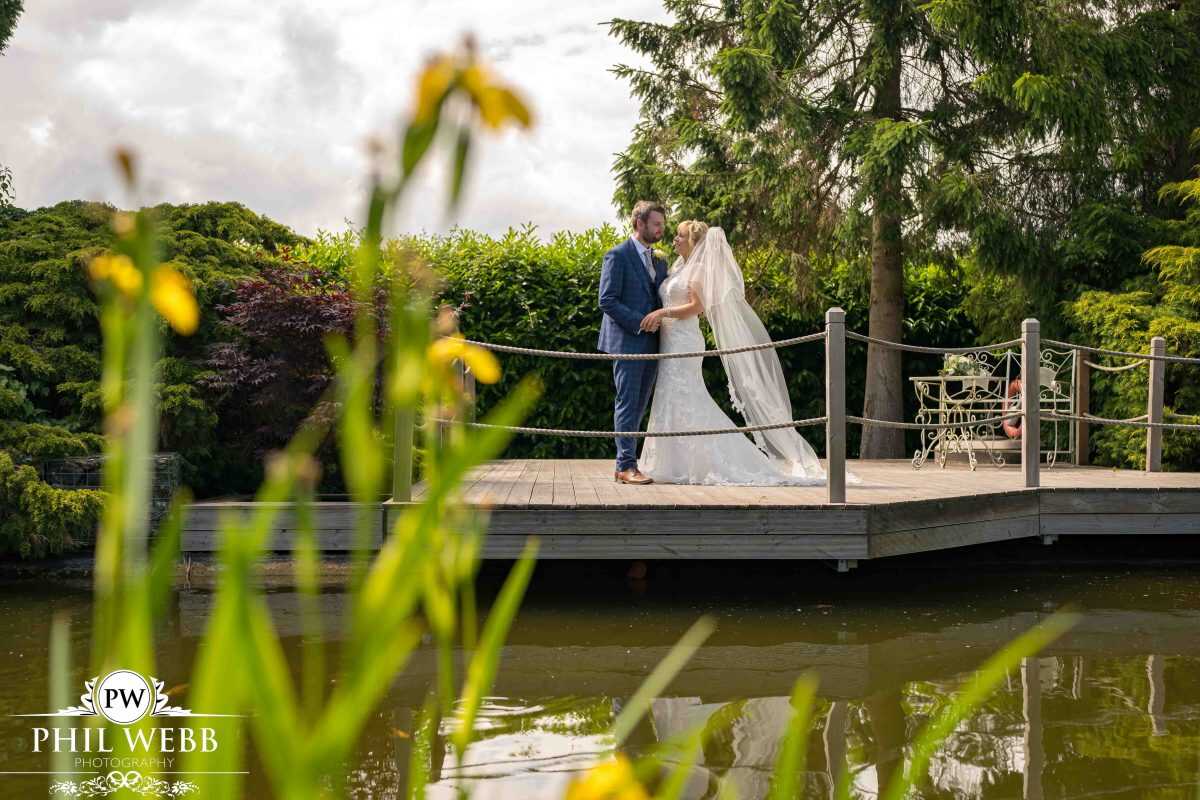 bride and groom portrait redhouse barns over lake