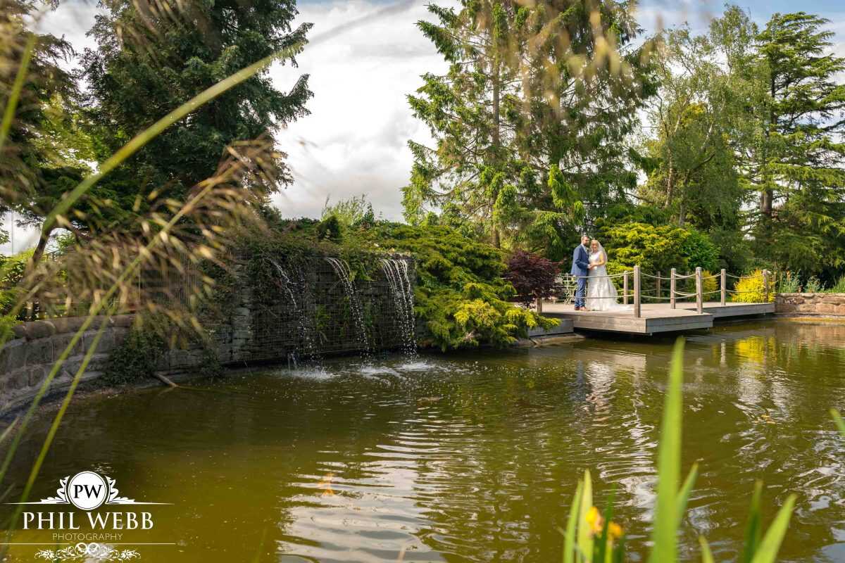bride and groom portrait redhouse barns over lake