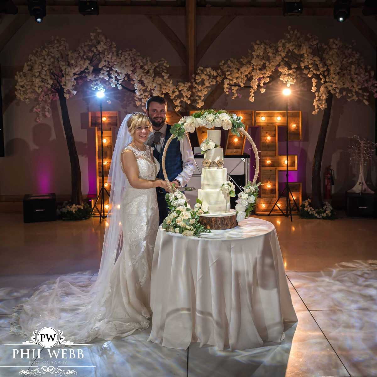 Redhouse barns bride and groom cutting the wedding cake