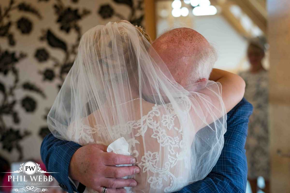 bride prep at Red House Barns Wedding Venue dad and bride hugging