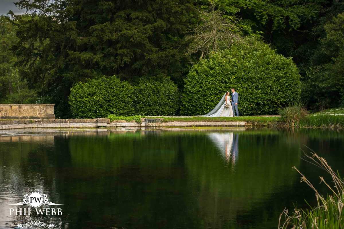 Bride and Groom Portrait at Cowley Manor by the lake